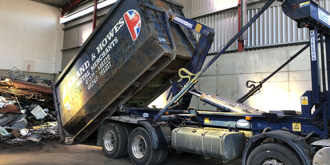 Skip tipper unloading rubbish.